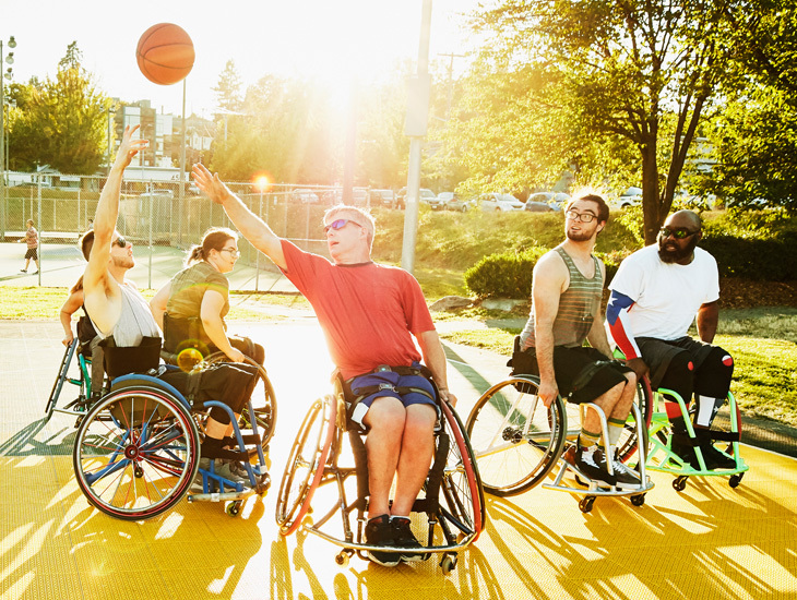 People on wheelchairs playing basketball